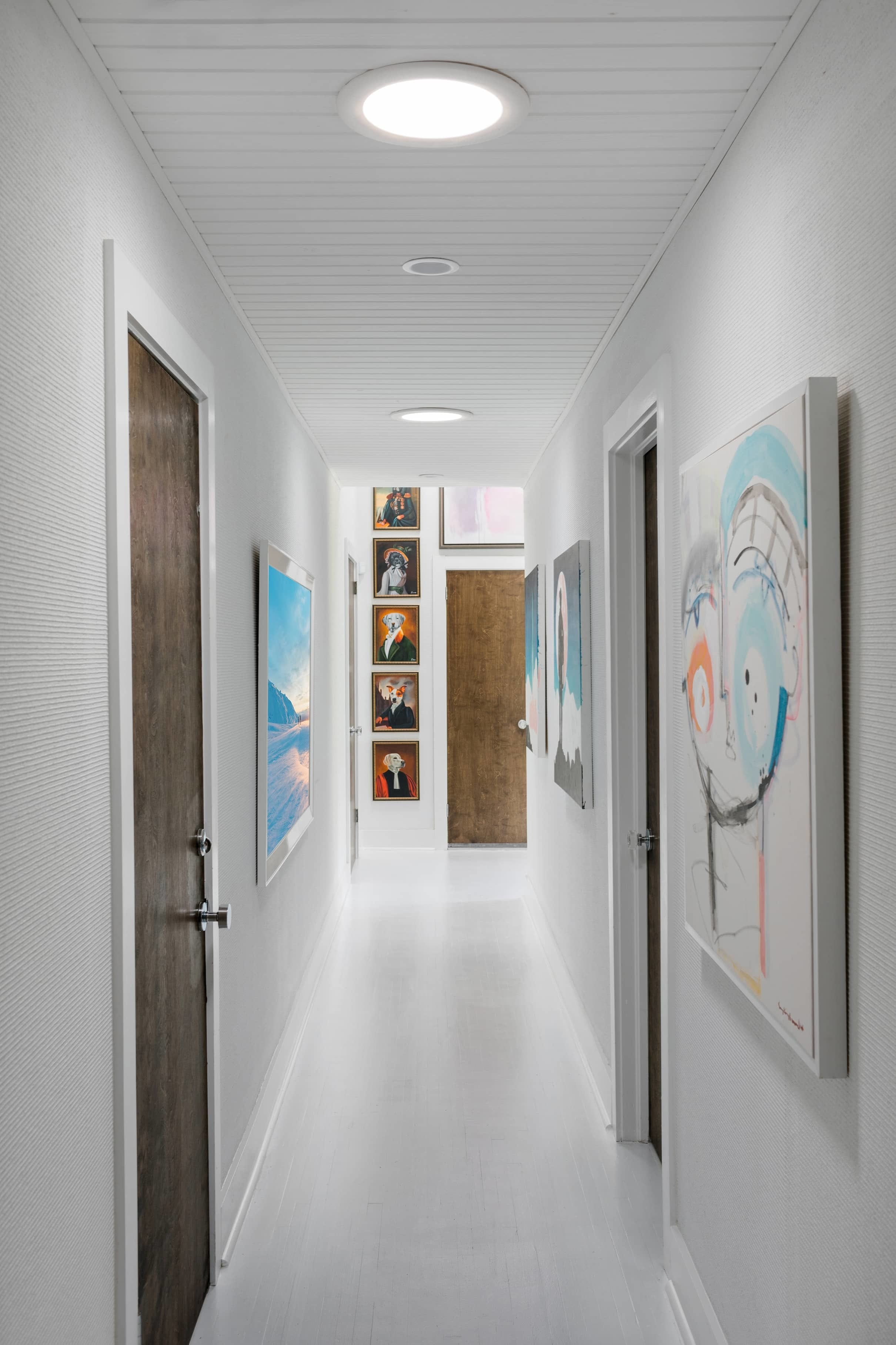 White hallway art gallery with Sun Tunnel skylights