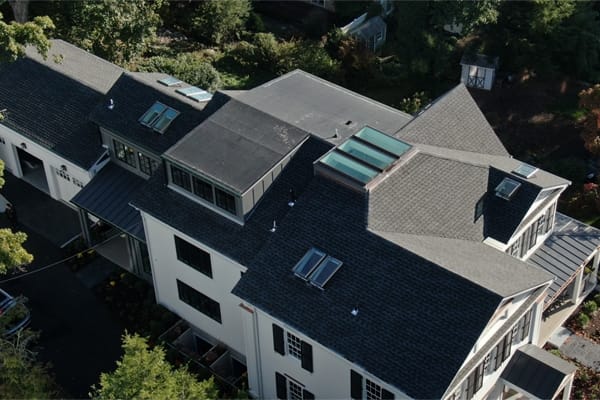 A birdseye view of a house with many skylights on the roof