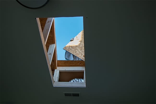 A view of the sky after the roof hole has been cut for a skylight