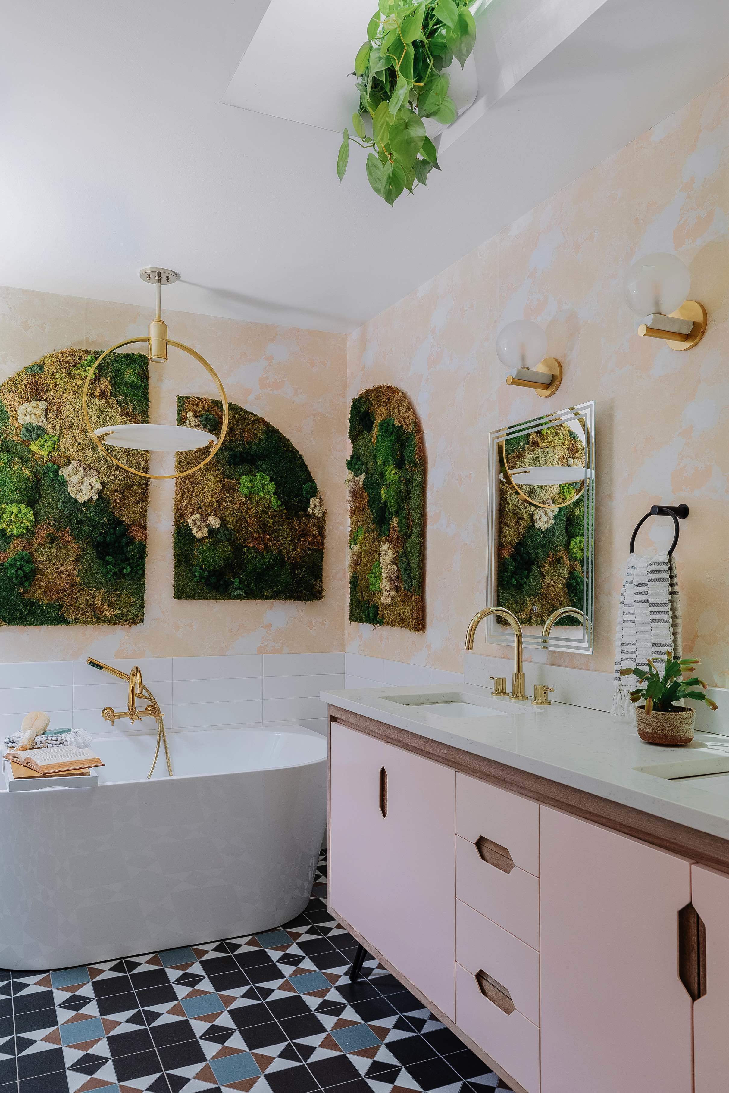 Pink vanity bathroom with moss walls and skylight with hanging plants