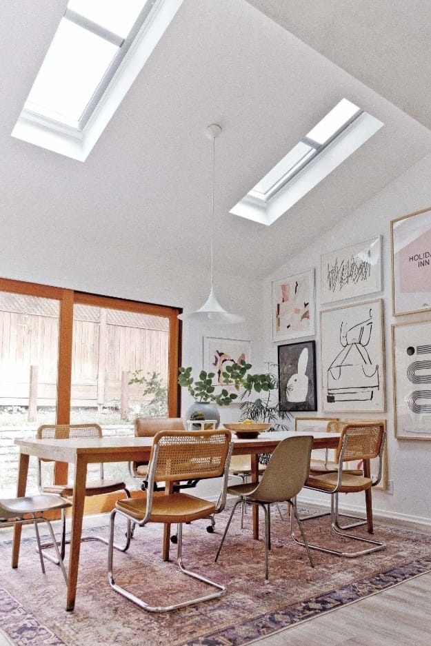 Dining room with skylights and gallery wall