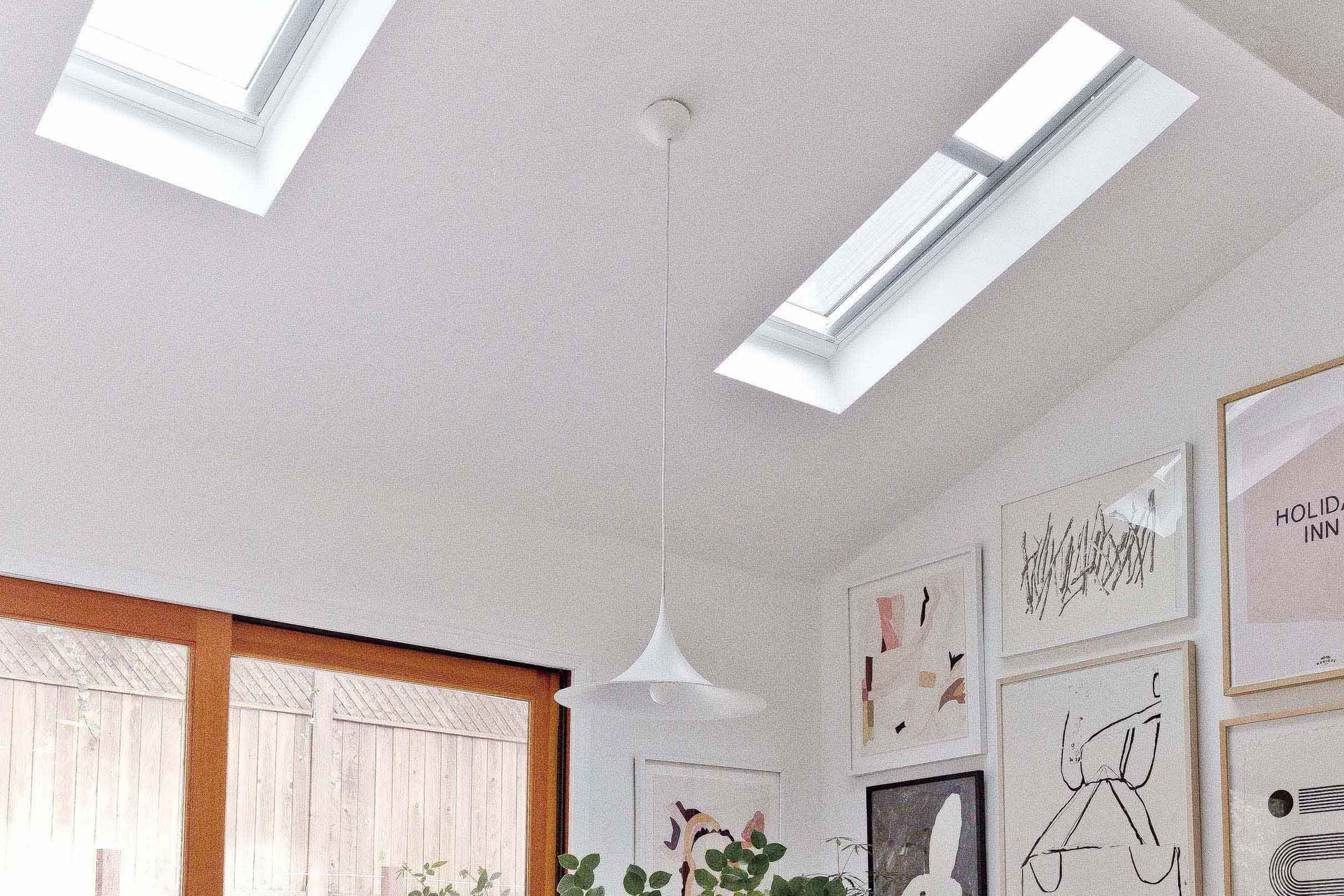 Dining room with skylights and gallery wall tmb