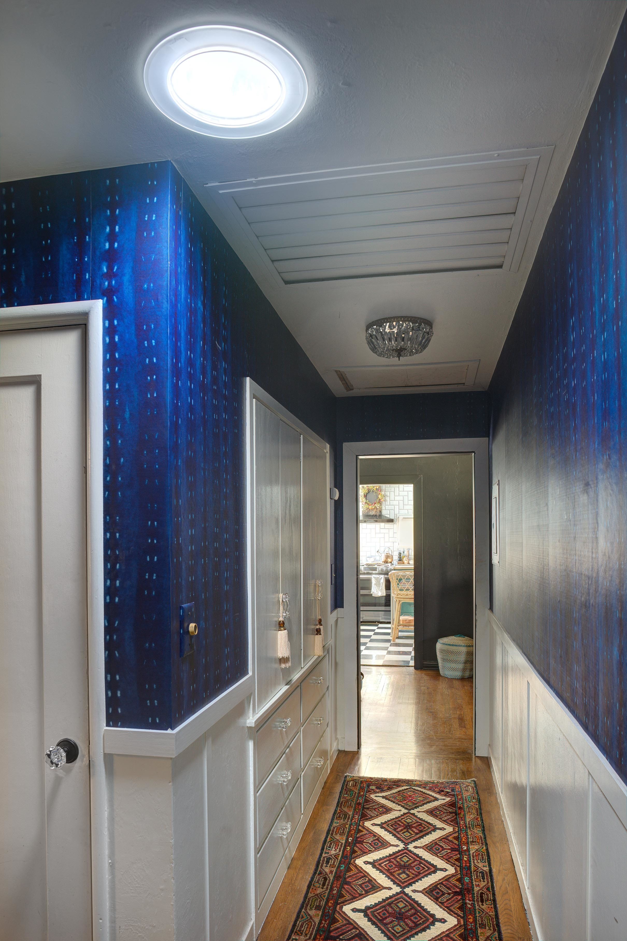 Hallway sun tunnel skylight blue wallpaper vintage rug