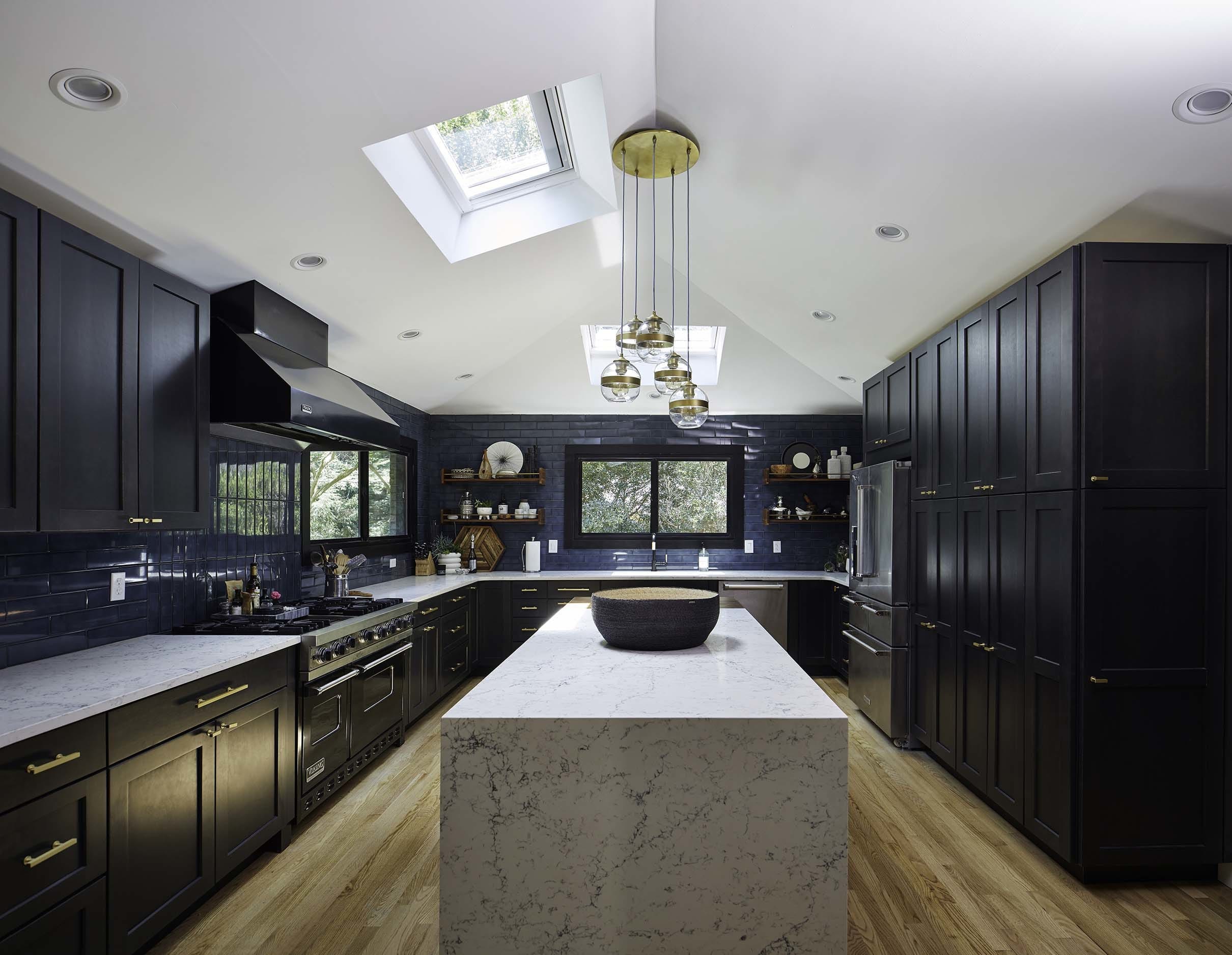 Kitchen black cabinets blue backsplash skylights
