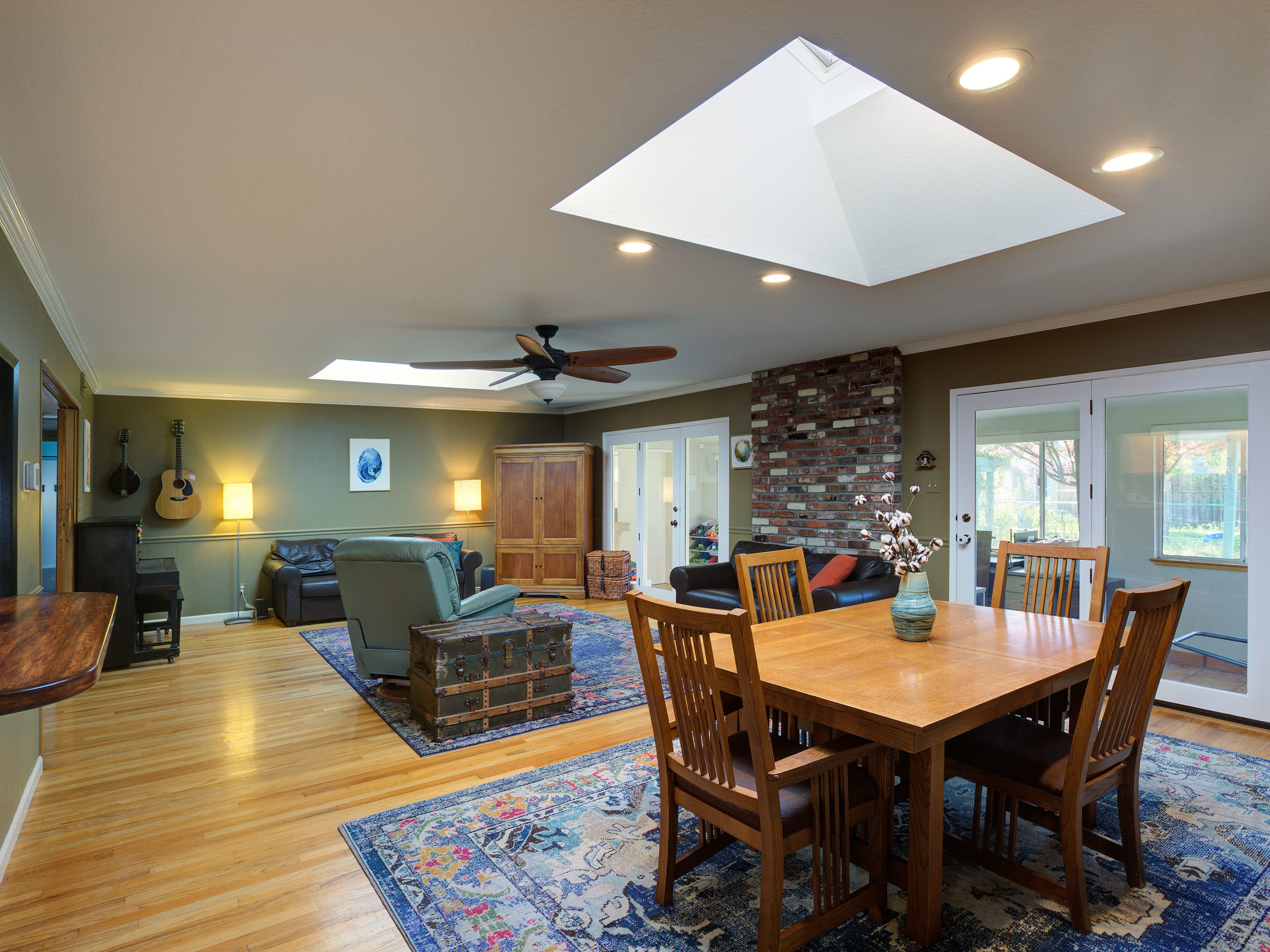 Open plan living room and dining room with two large skylights