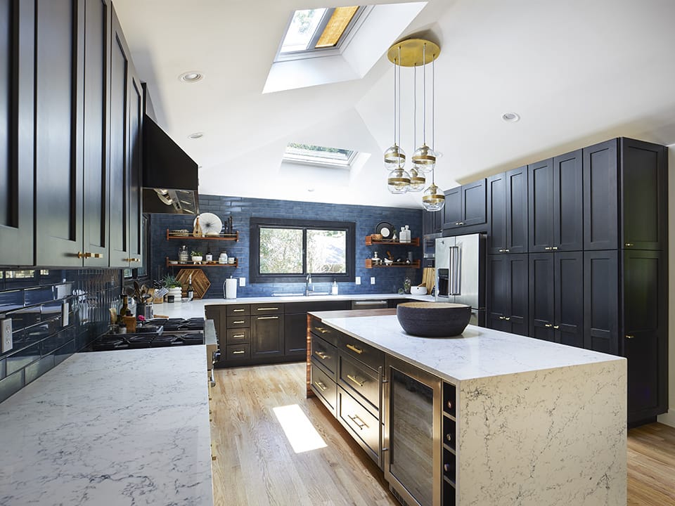 blue and black kitchen with two skylights