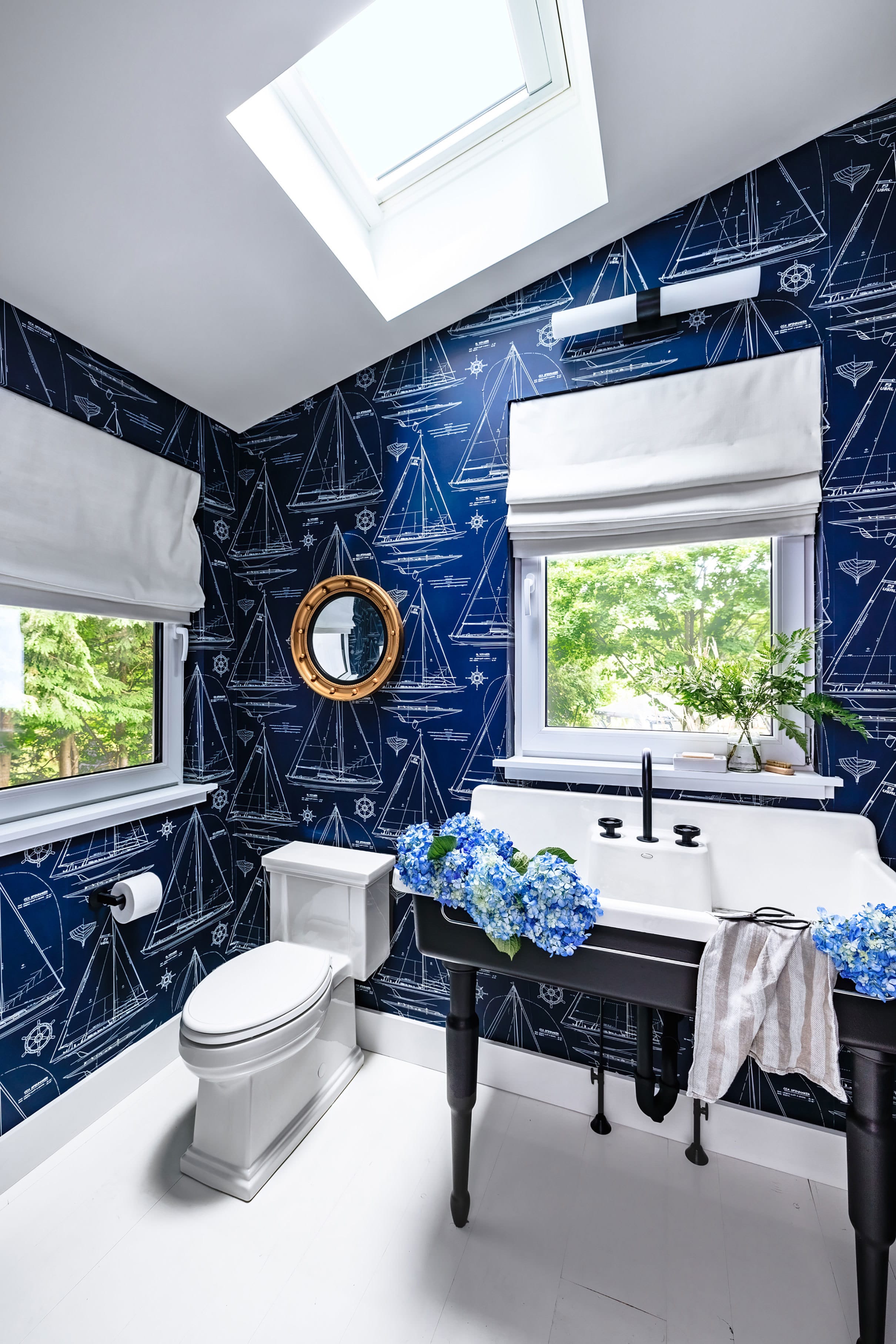 blue nautical themed powder room with skylight