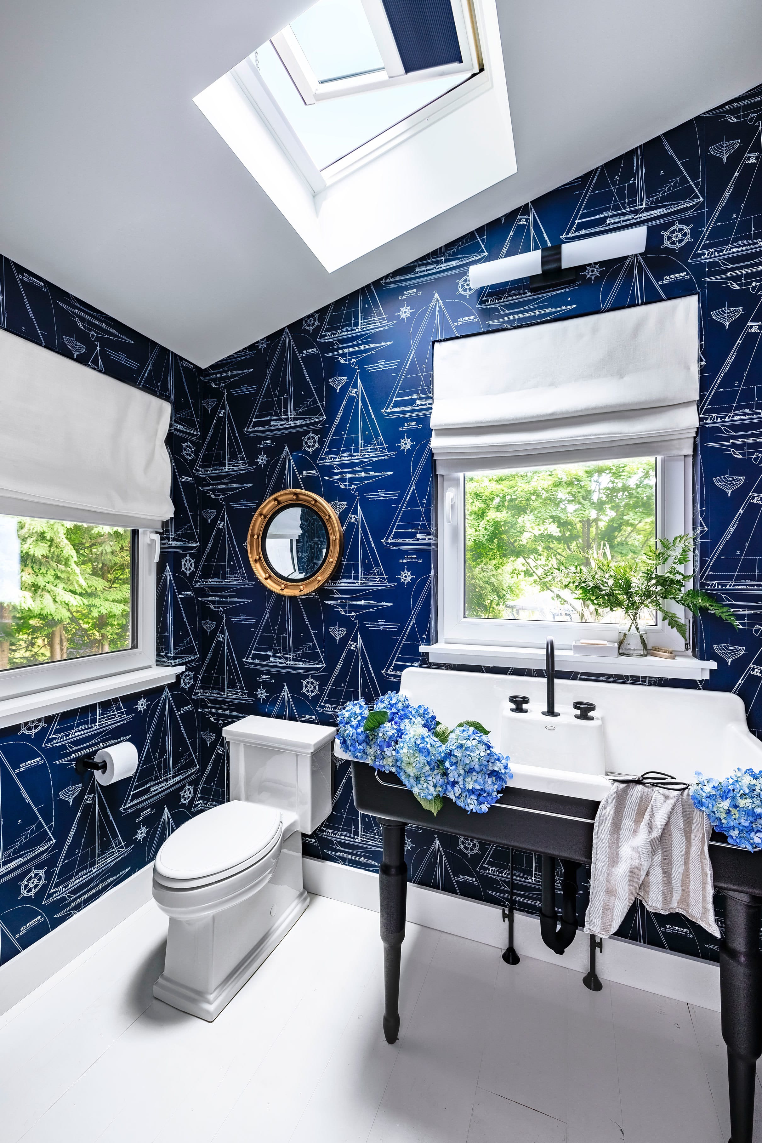 nautical themed blue bathroom with skylight