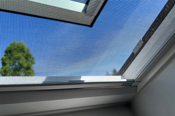 Open skylight with bug screen and blue sky beyond TMB