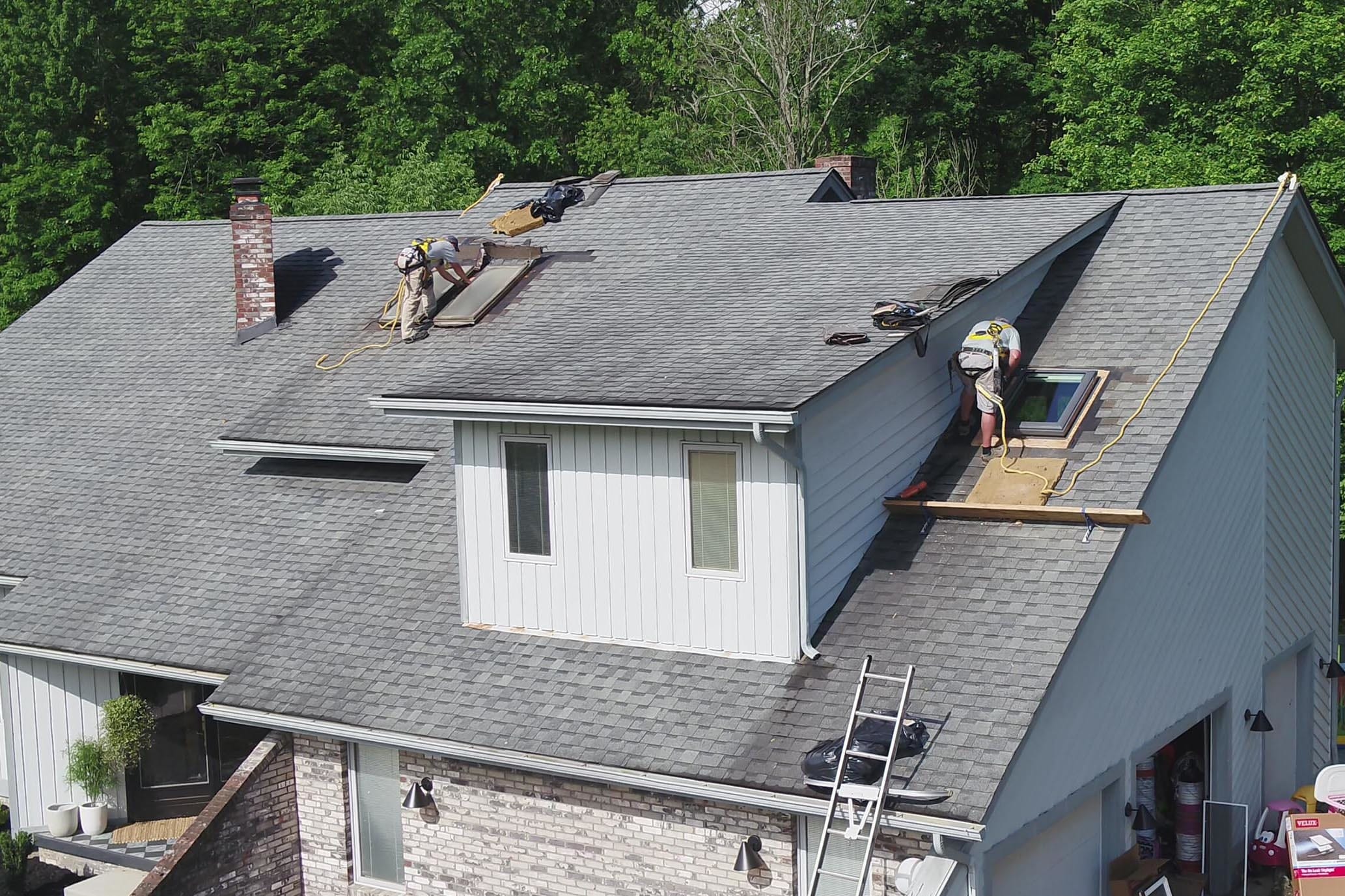 Skylight installers working on a roof small