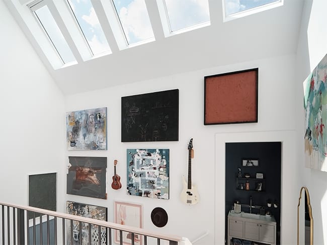 Top of a stairwell with skylights brightening a gallery wall