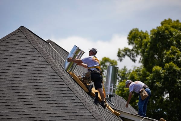 Two men on a roof installing a Sun Tunnel
