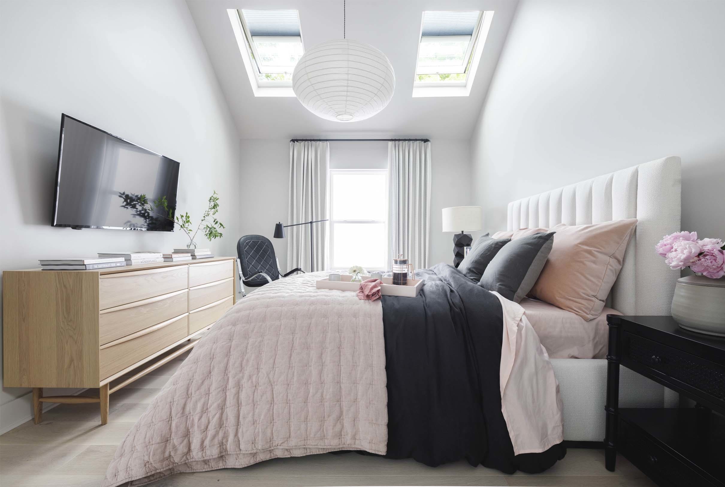 Bedroom pink comforter grey pillows skylights