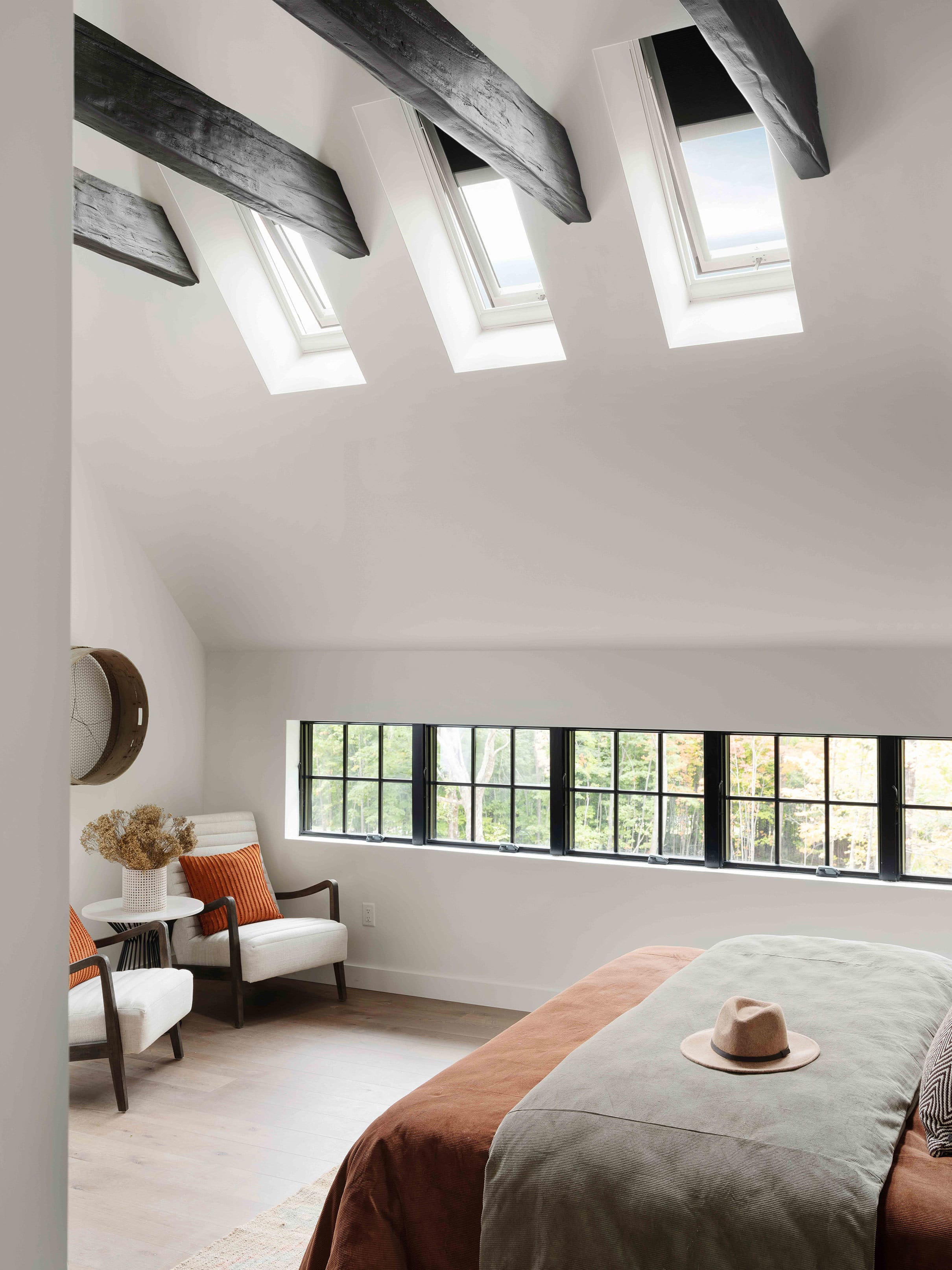 Bedroom skylights white walls timber beams