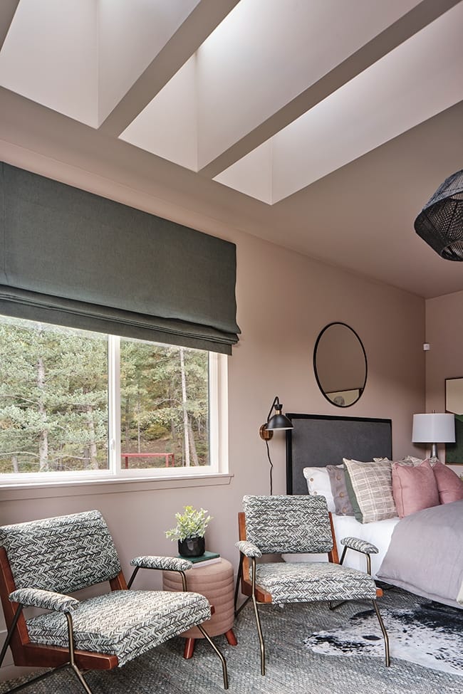 Bedroom with pink walls three skylights and gray accents
