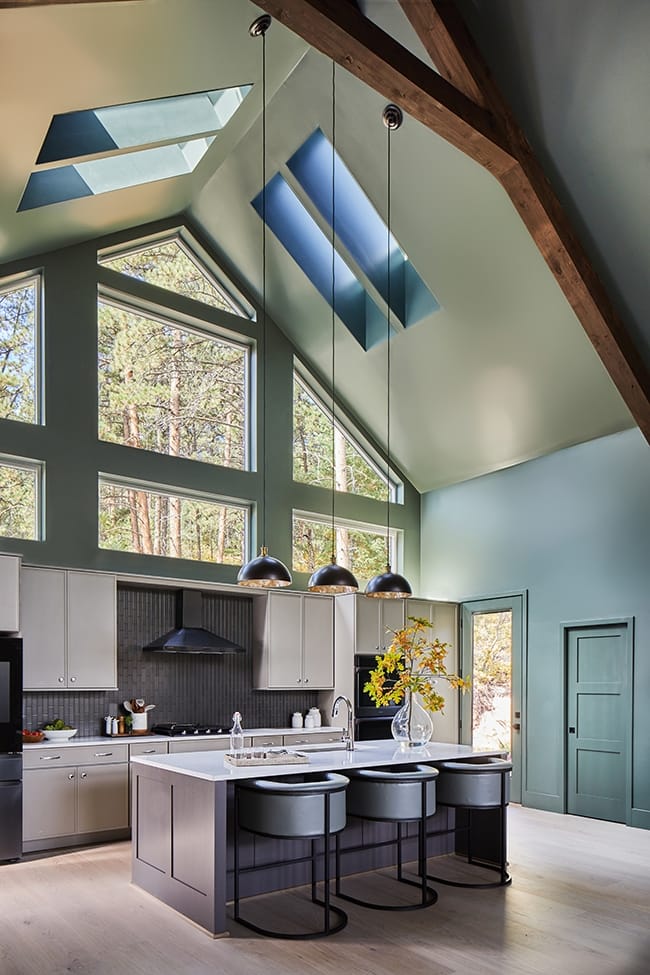 Four skylights brighten a gray green kitchen