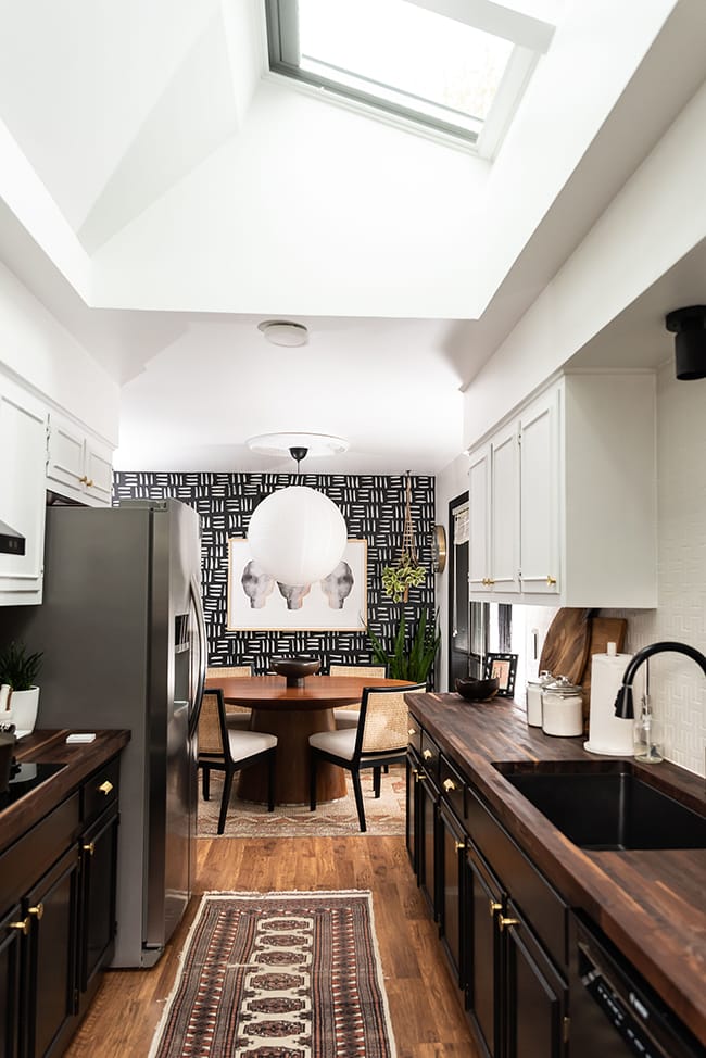 Galley kitchen after skylights installed black and white