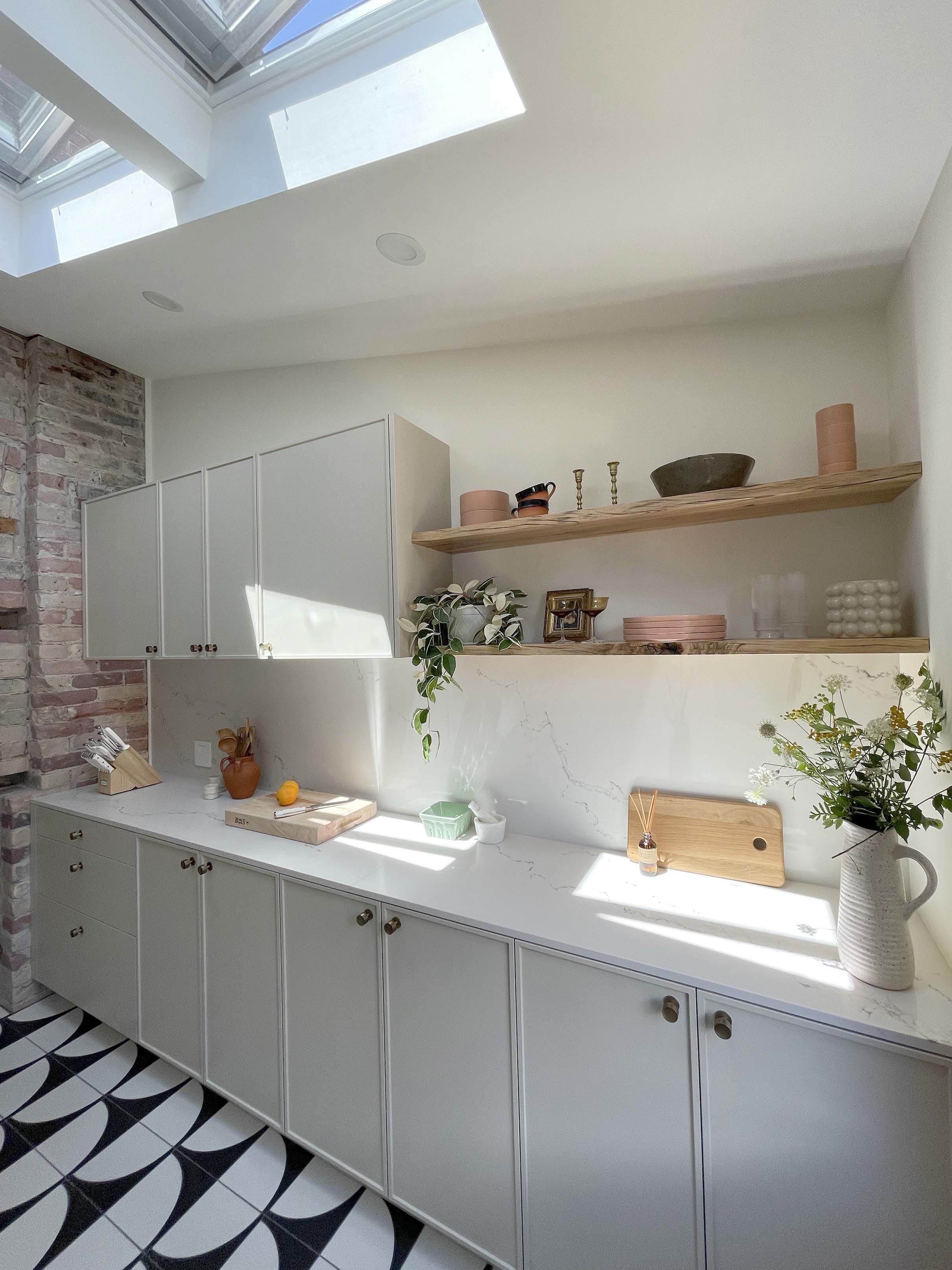 Kitchen skylights gray cabinets white countertop plants