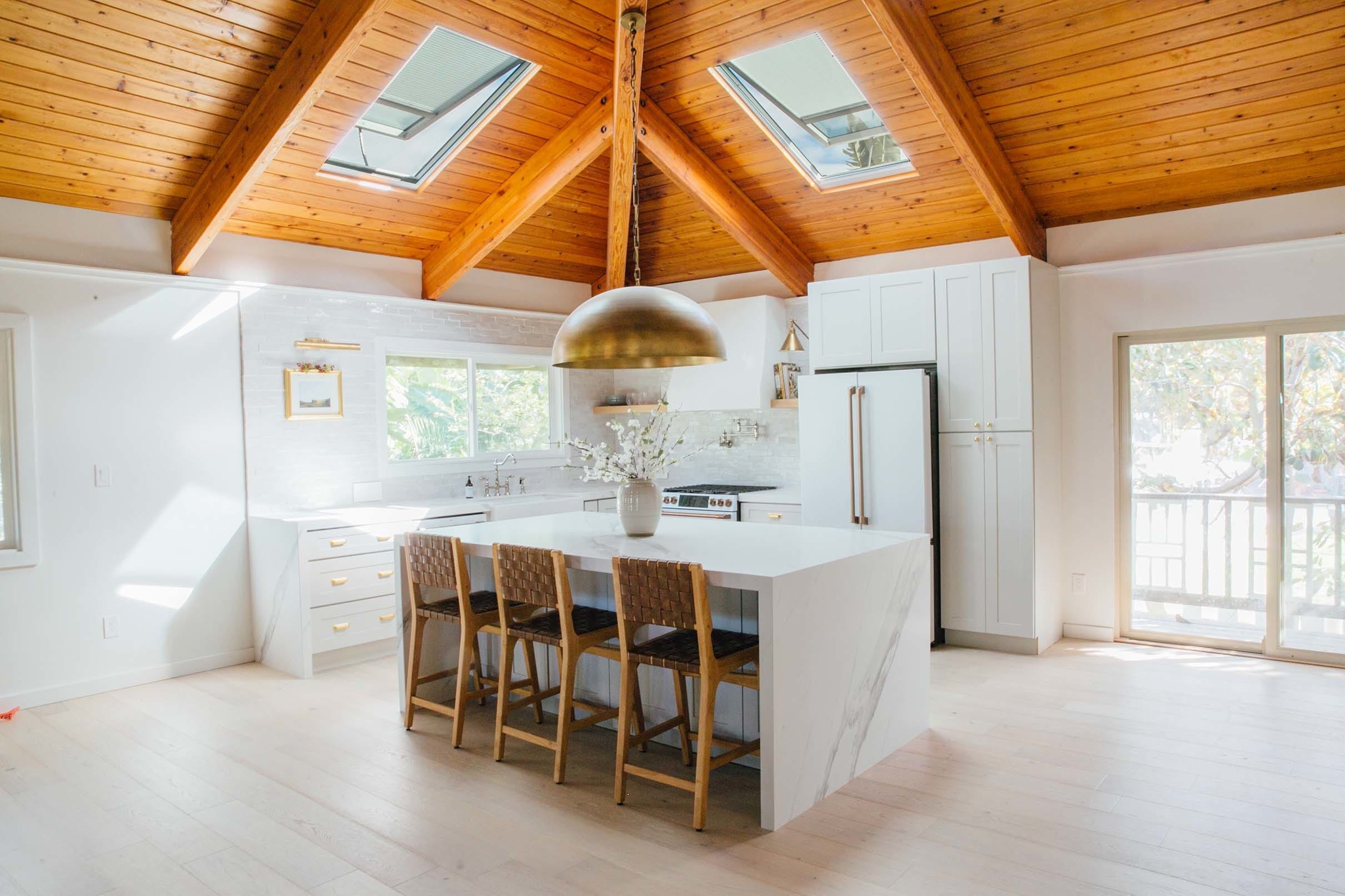 Kitchen wood ceiling skylights white island