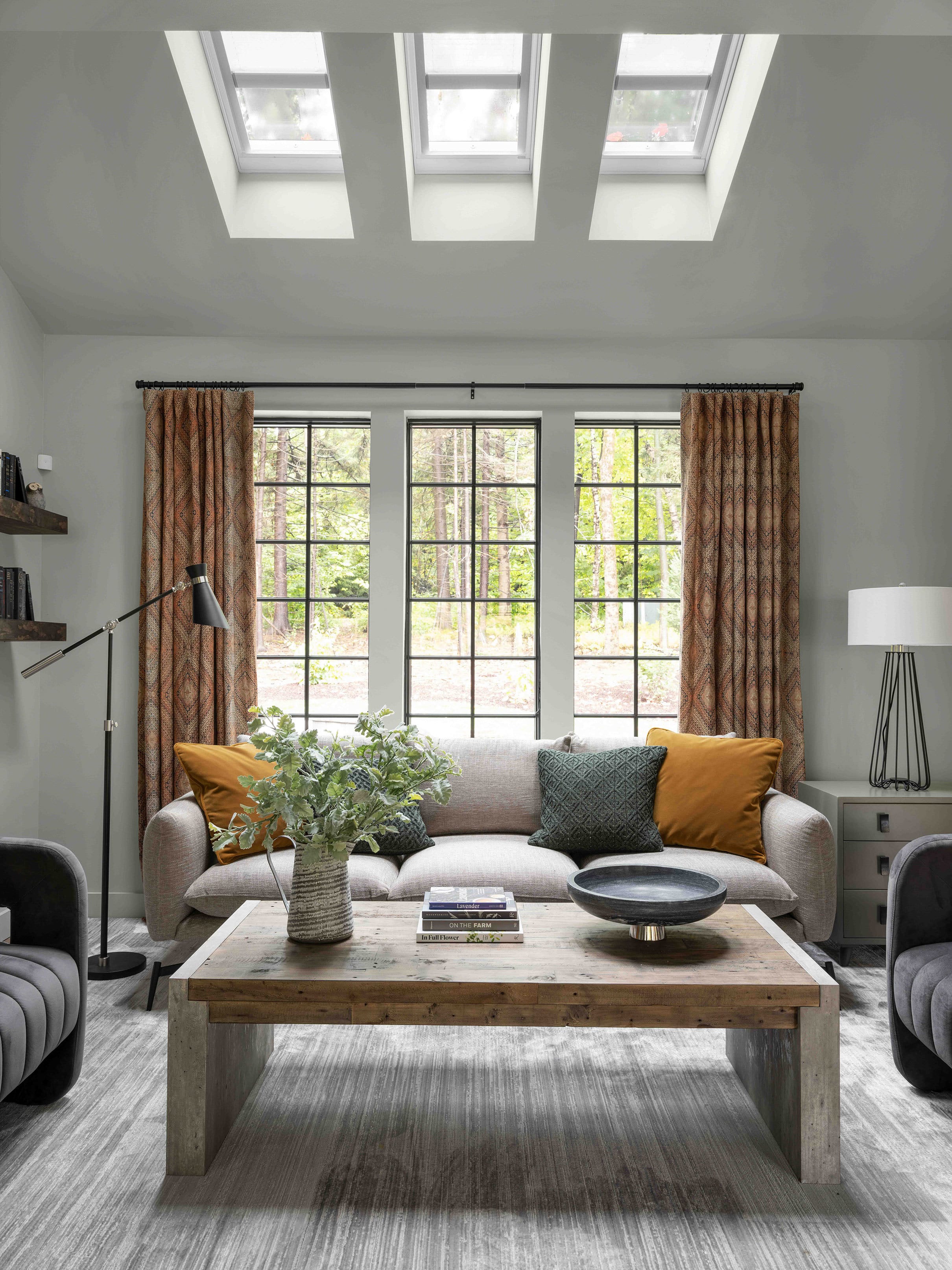 Living room skylights orange curtains gray rug