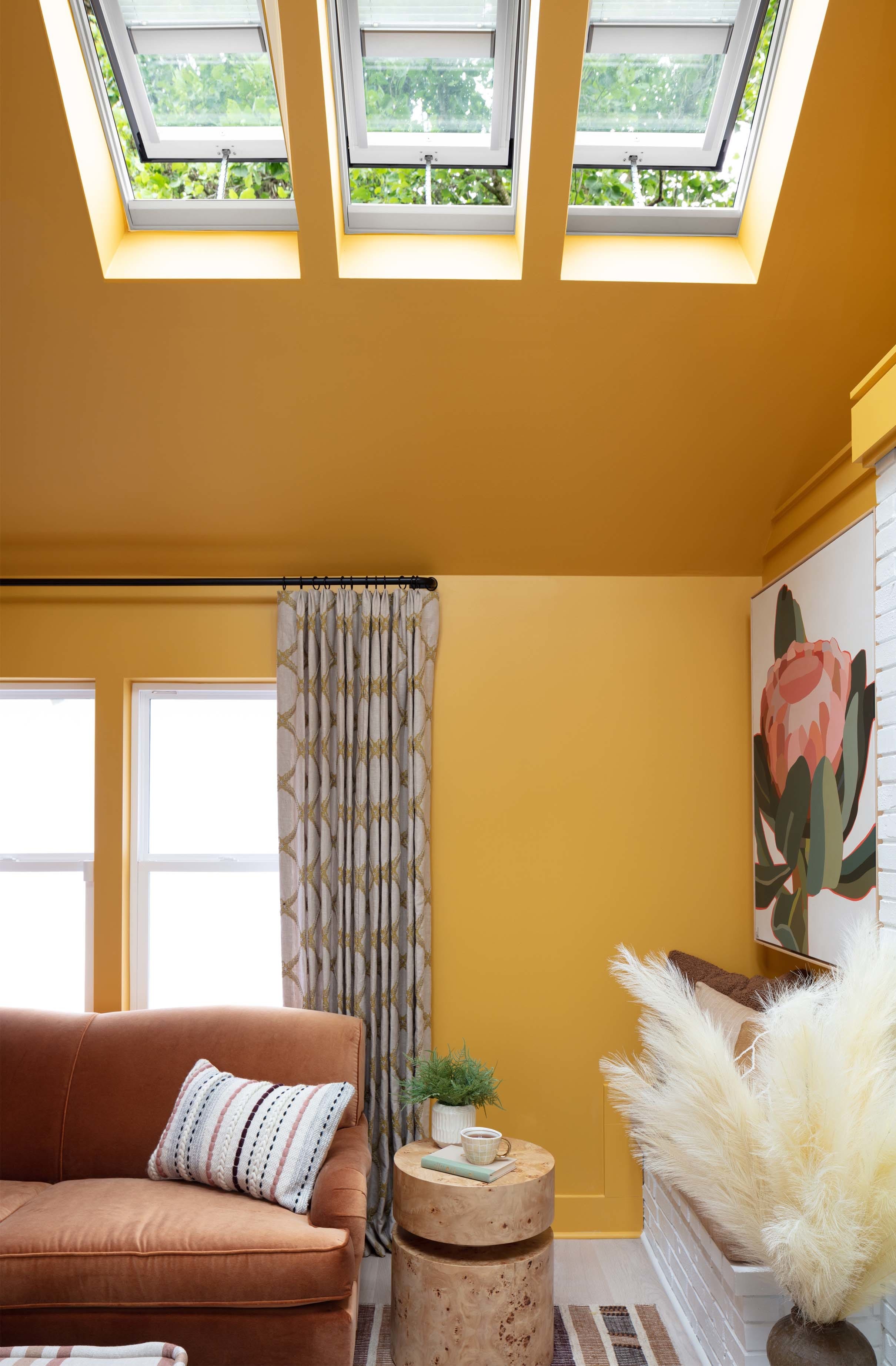 Living room skylights rust sofa yellow walls
