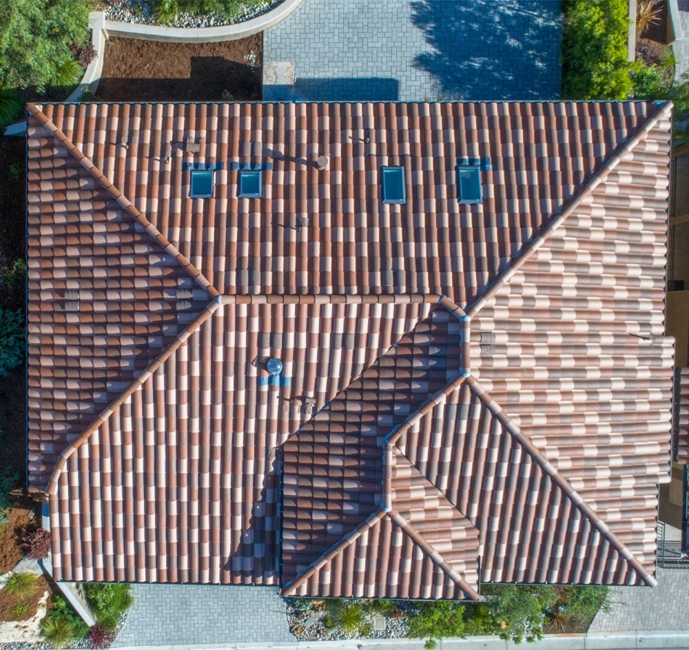 Four skylights on a barrel tile roof viewed from above