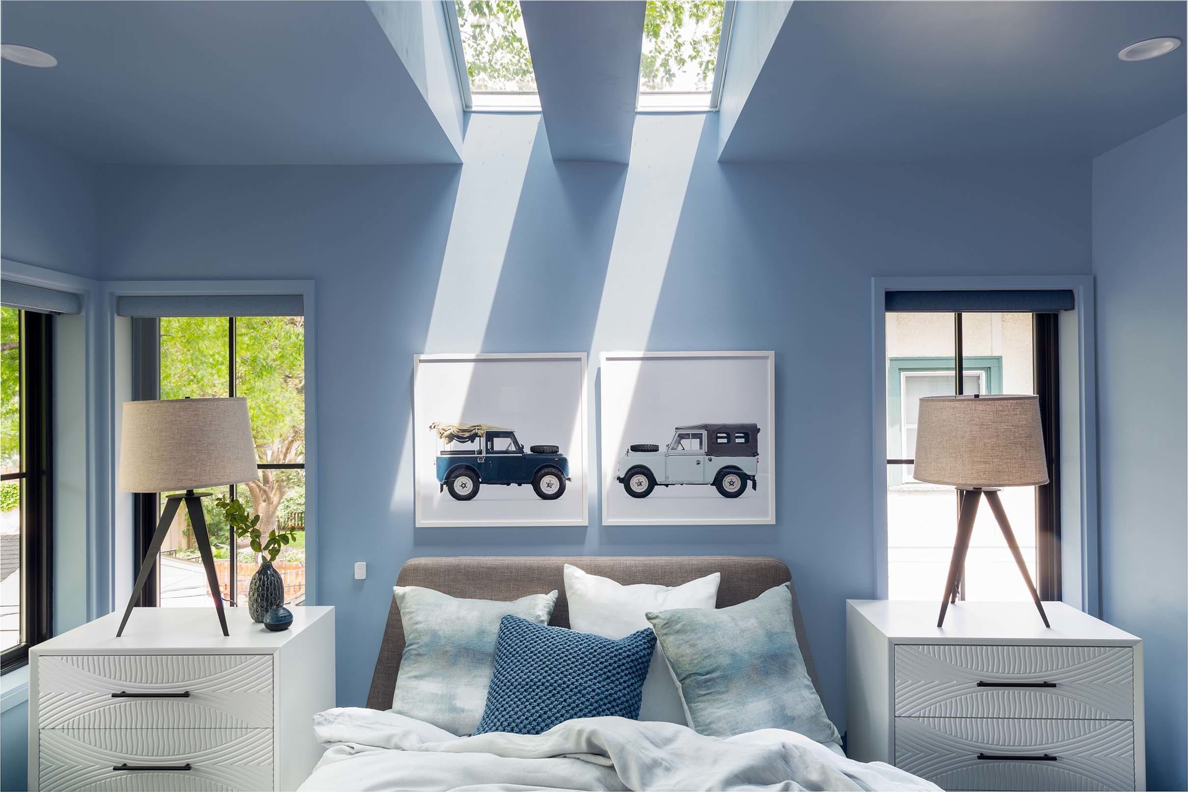Primary bedroom blue skylights car art