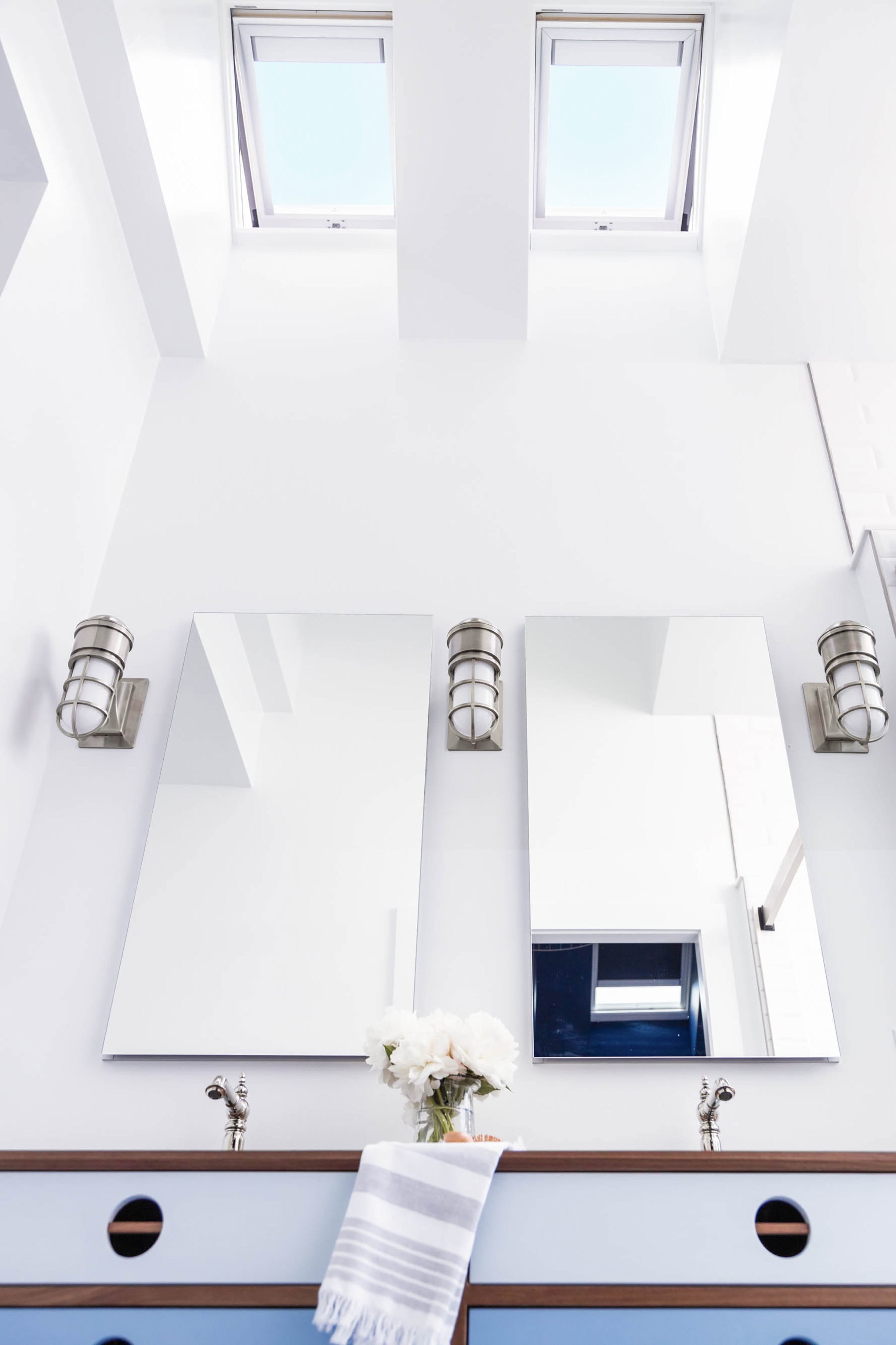 two skylights brighten a blue tonal bathroom