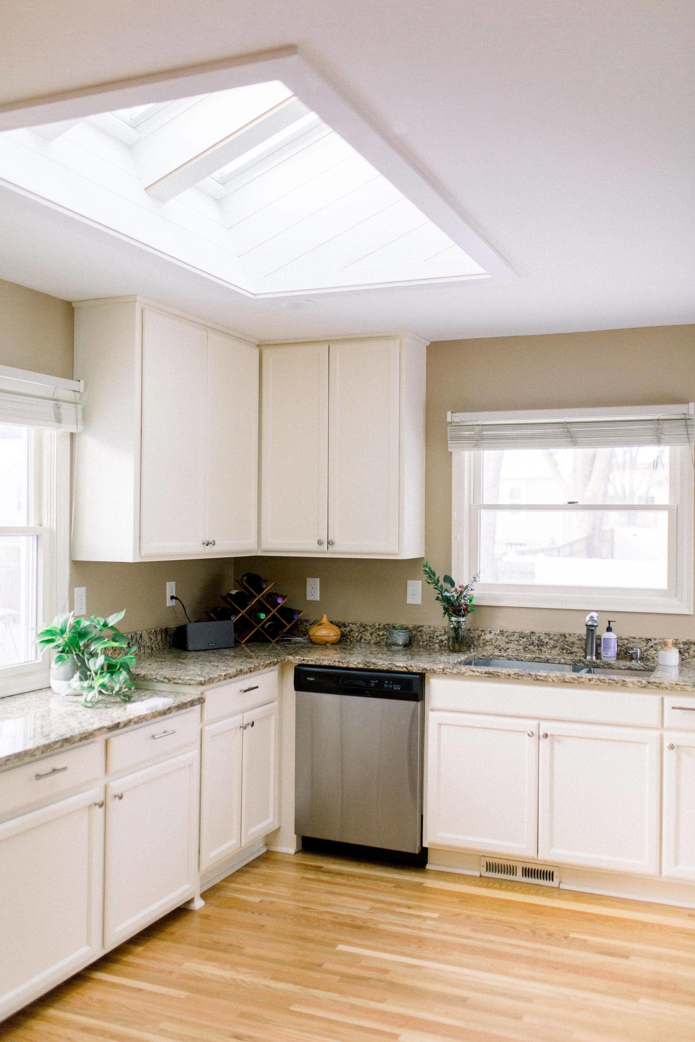 White and beige kitchen three skylights