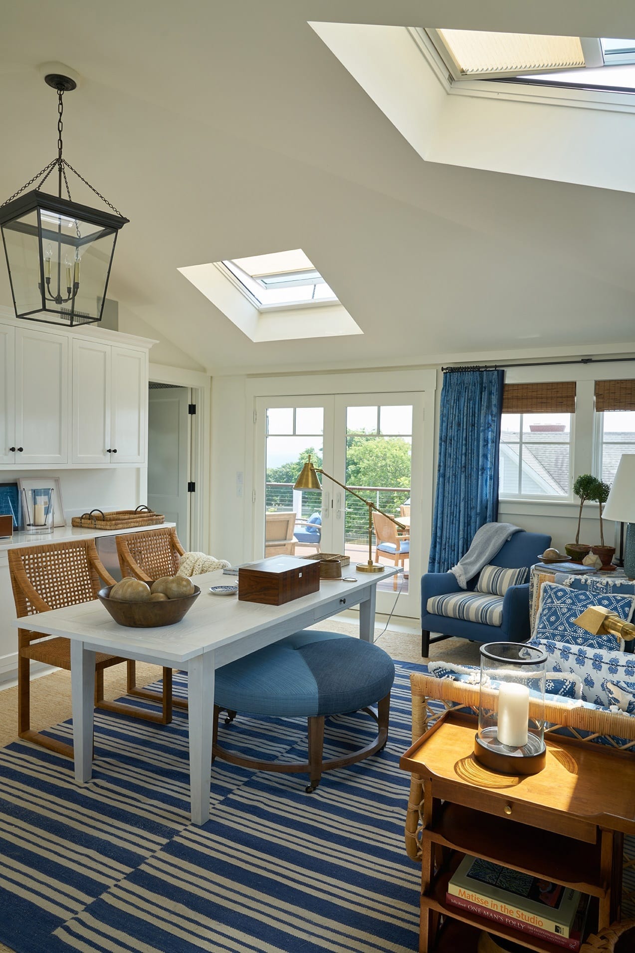 White home office room with blue accents and two skylights