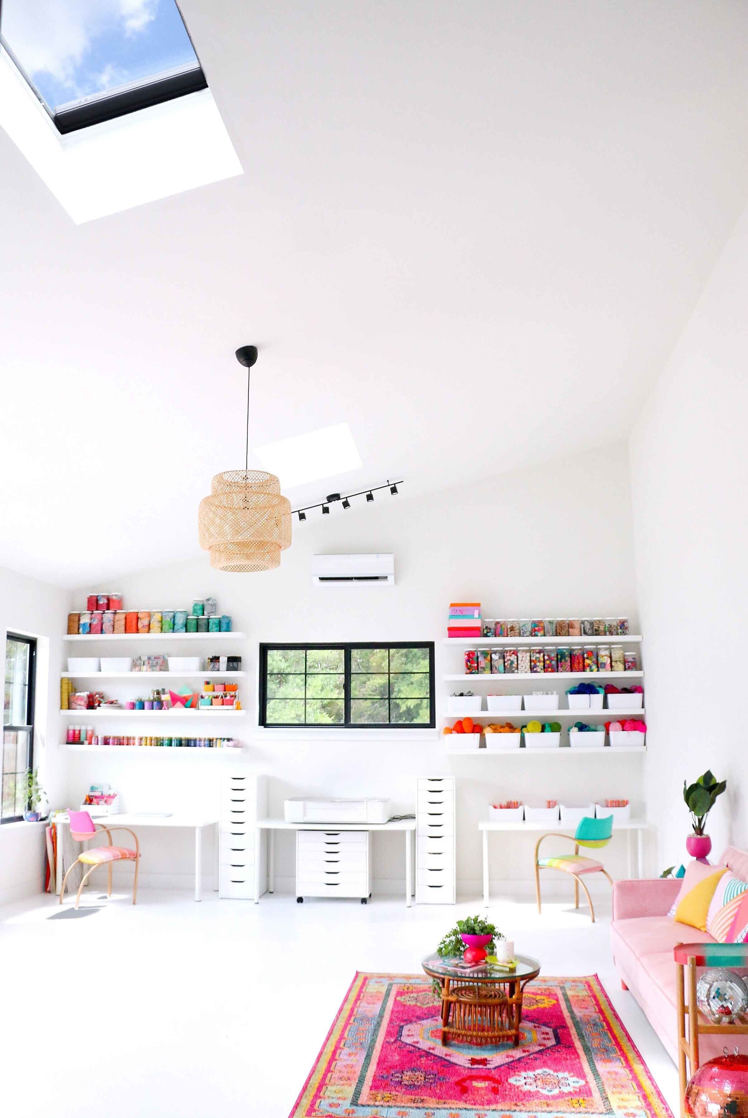 Bright white art studio with two skylights on a vaulted ceiling