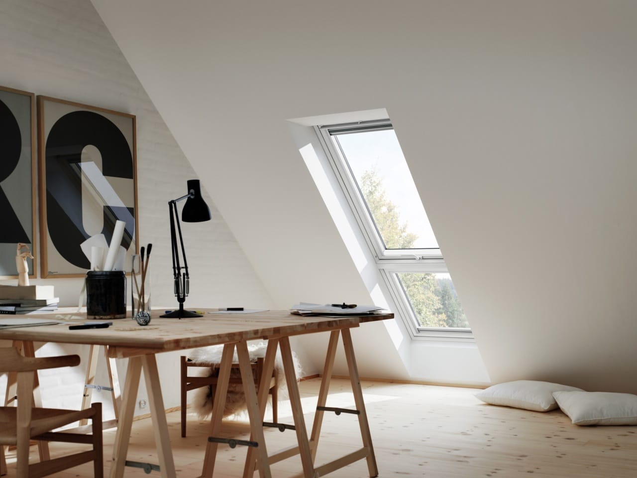Home office studio in an attic with a skylight touching the floor