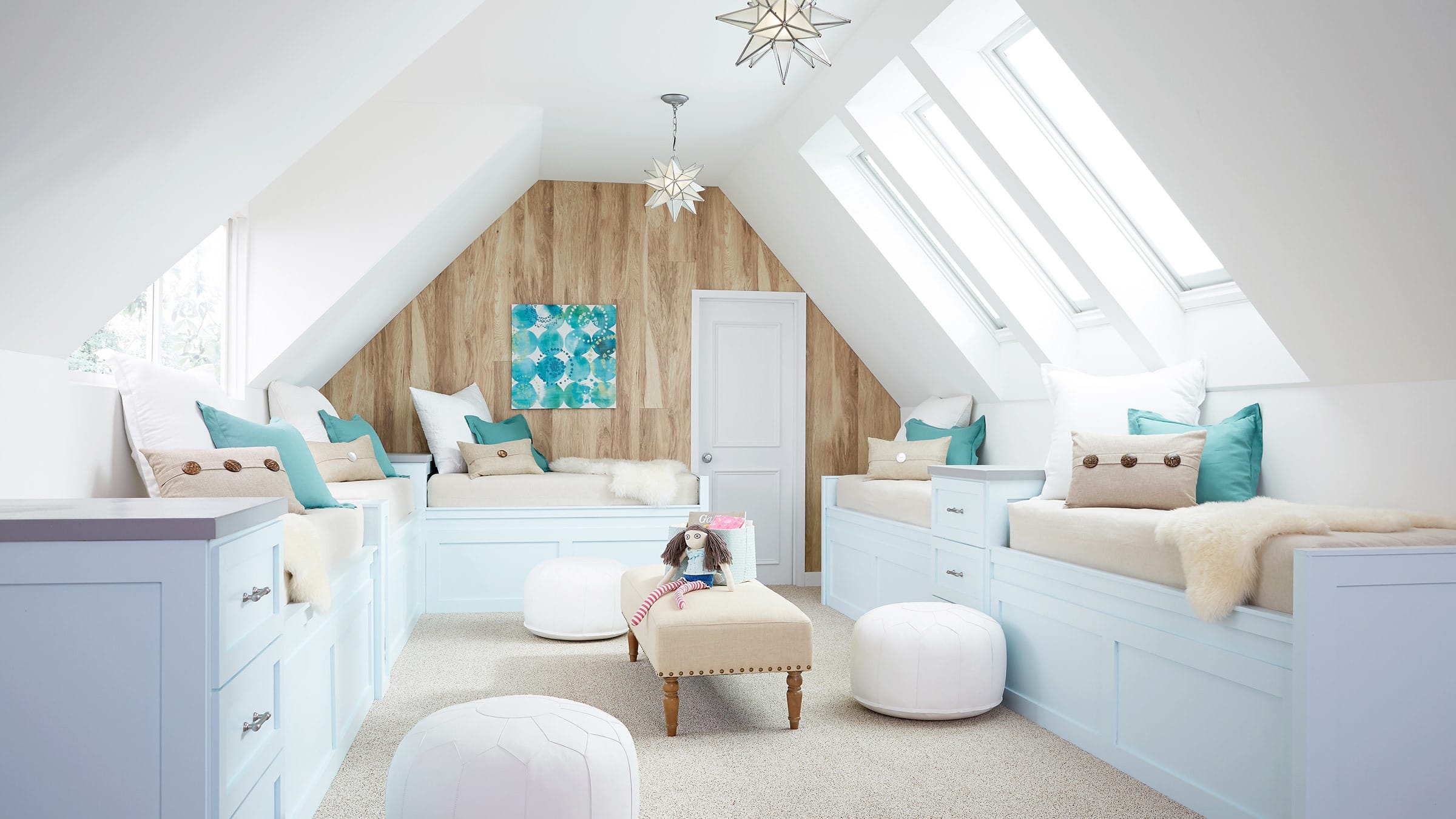 Bright white attic children’s bonus room with three skylights and a window
