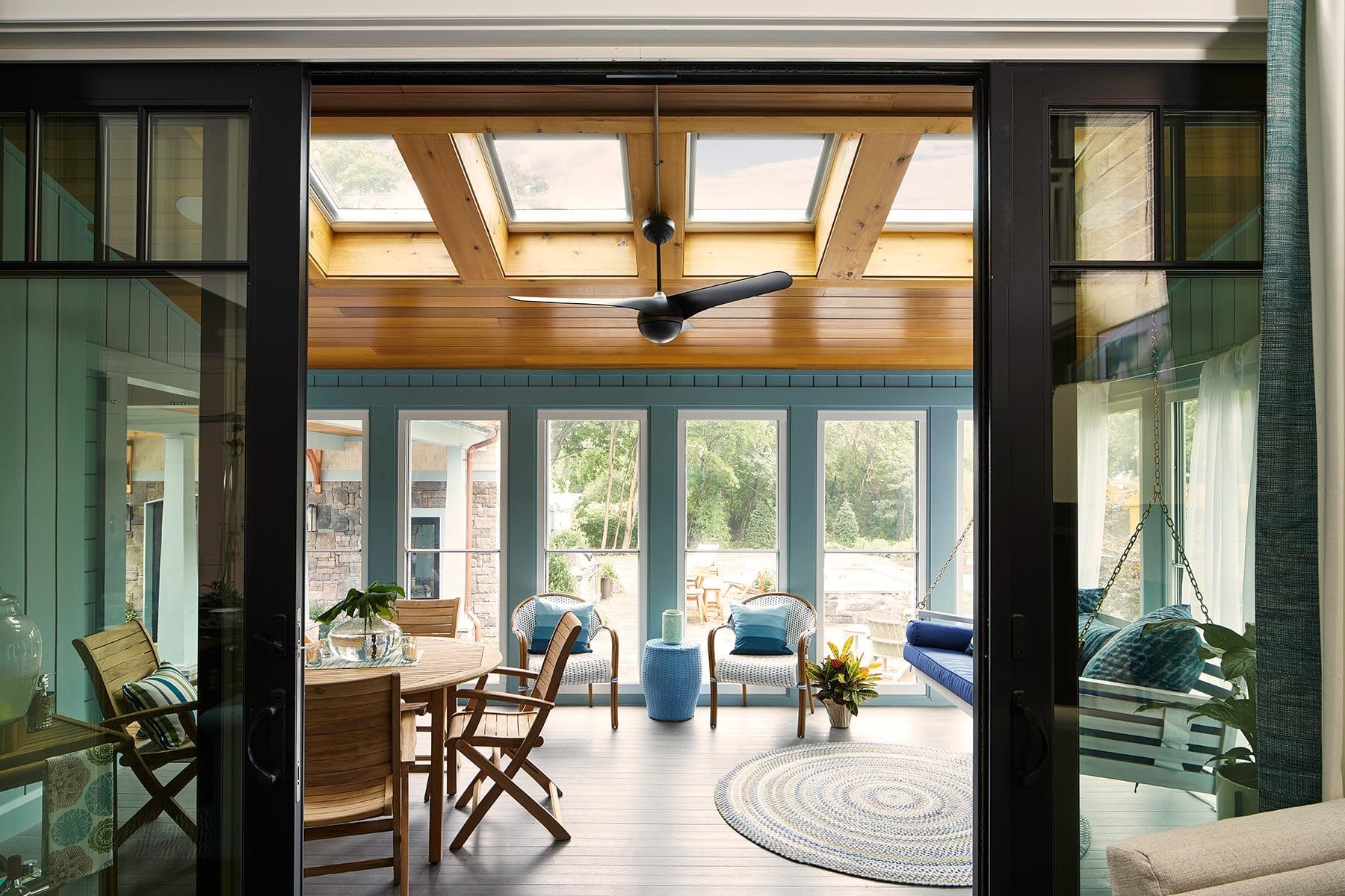 Blue sunroom with four skylights on a wooden ceiling